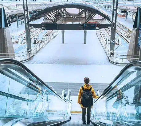 ESG & Sustainability. A person on the escalator to the train platform