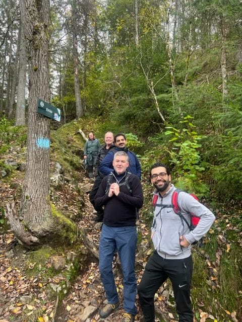Social Impact Initiatives. Employees walking in the woods