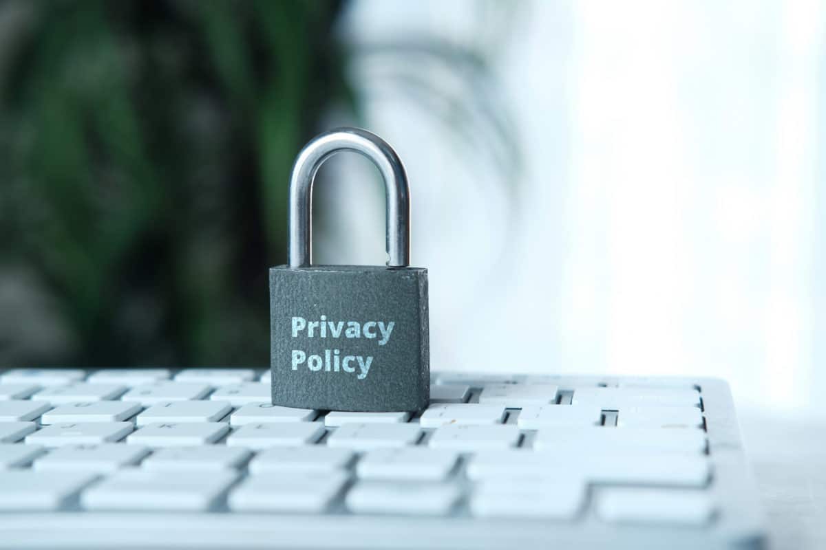 Privacy policy. Laptop keyboard with padlock on top with Privacy Policy written on it.