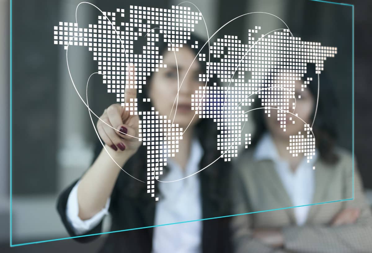 Supply Chain Management. Two people looking at digital global distribution map